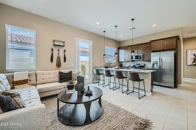 living room with baseboards, recessed lighting, and light tile patterned floors