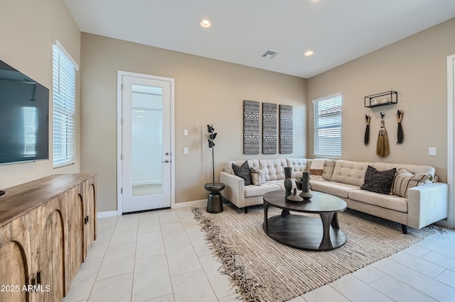 living room featuring light tile patterned flooring, plenty of natural light, recessed lighting, and baseboards