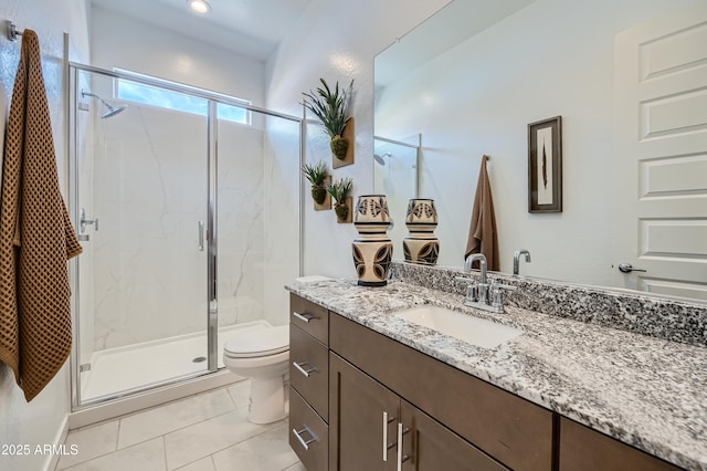 bathroom with toilet, a marble finish shower, vanity, and tile patterned flooring