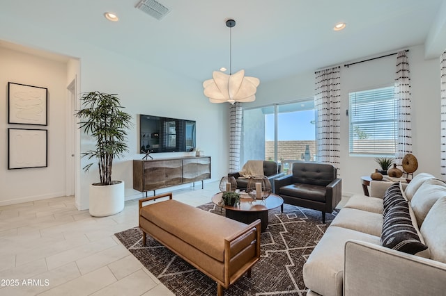 tiled living area featuring recessed lighting and baseboards
