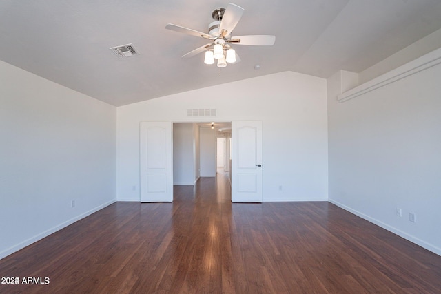 spare room featuring lofted ceiling, ceiling fan, and dark wood-type flooring