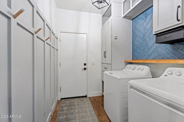 washroom with cabinets, washing machine and clothes dryer, and dark hardwood / wood-style flooring