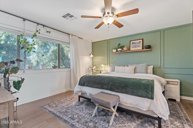 bedroom with ceiling fan and dark hardwood / wood-style flooring