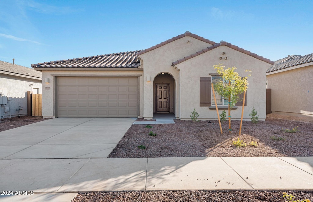 mediterranean / spanish-style house featuring a garage