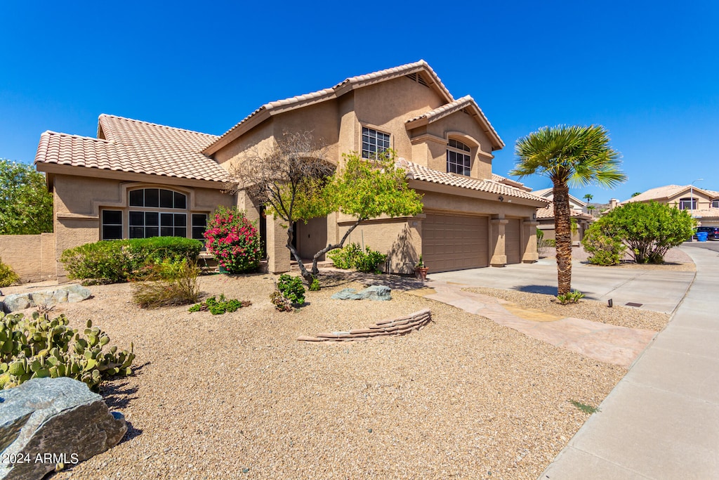 mediterranean / spanish-style home featuring a garage