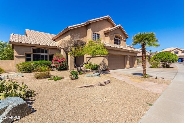 mediterranean / spanish-style home featuring a garage