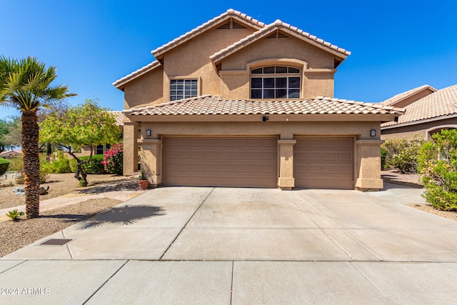 mediterranean / spanish-style home with a garage