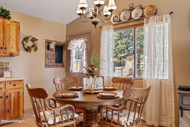 dining room with light tile patterned floors, vaulted ceiling, an inviting chandelier, and a wealth of natural light