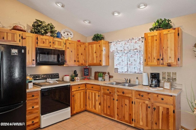 kitchen featuring sink, a textured ceiling, lofted ceiling, light tile patterned flooring, and black appliances