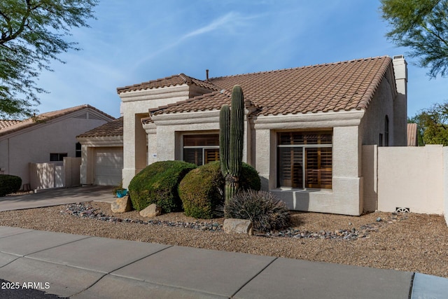 mediterranean / spanish house with a garage