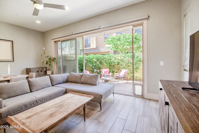 living area with recessed lighting and a ceiling fan
