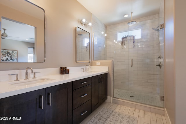 full bathroom featuring a sink, tile patterned flooring, a shower stall, and double vanity