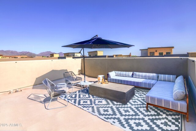 view of patio / terrace with an outdoor hangout area and a mountain view