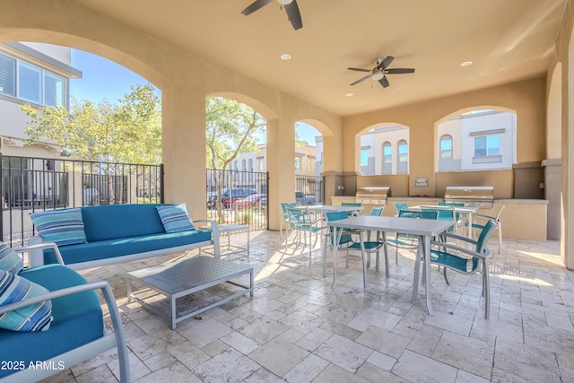 view of patio / terrace with area for grilling, ceiling fan, fence, and outdoor dining space
