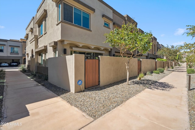 7464 E Paraiso Dr, Scottsdale, AZ 85255 - view of side of home featuring a fenced front yard, a gate, and stucco siding