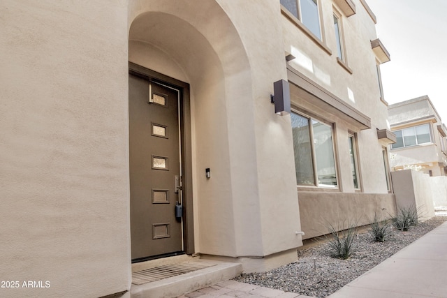 property entrance with stucco siding