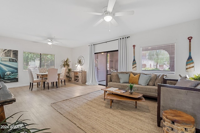 living room with ceiling fan and light wood-type flooring