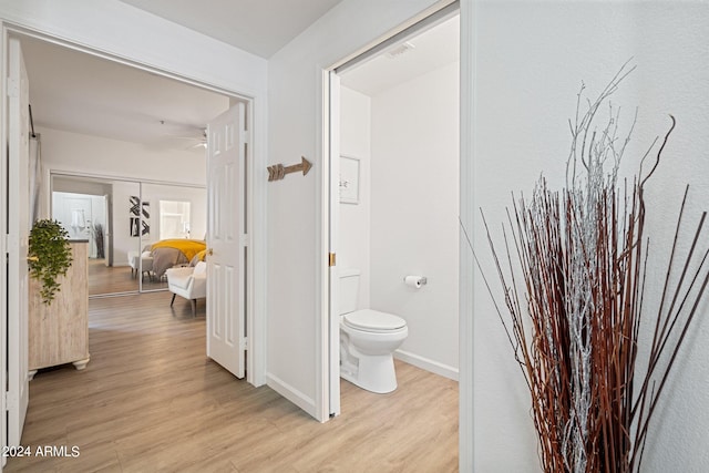 bathroom featuring hardwood / wood-style flooring and toilet