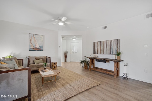 living room featuring ceiling fan and hardwood / wood-style flooring