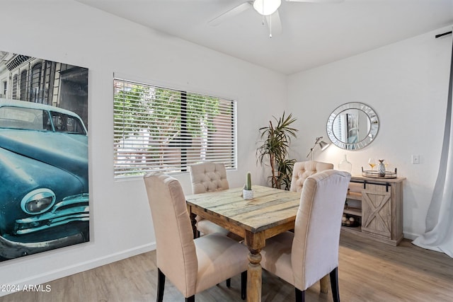 dining area featuring light wood-type flooring and ceiling fan