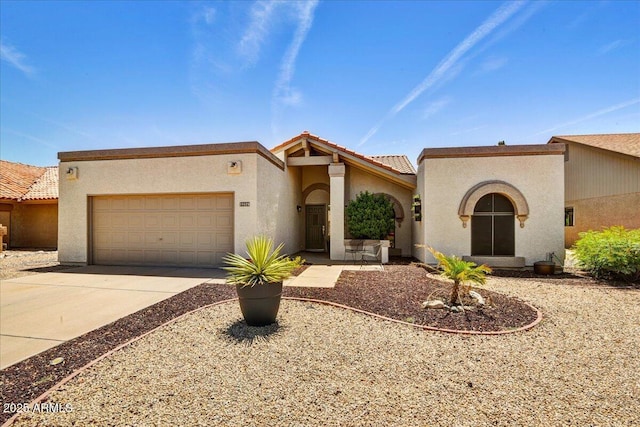 19025 N 96th Ave, Peoria, AZ 85382 - mediterranean / spanish-style home with a garage, concrete driveway, stucco siding, and a tiled roof