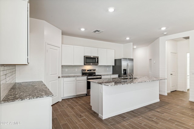 25467 W Graham Trl, Buckeye, AZ 85326 - kitchen with dark wood-style flooring, visible vents, tasteful backsplash, and appliances with stainless steel finishes