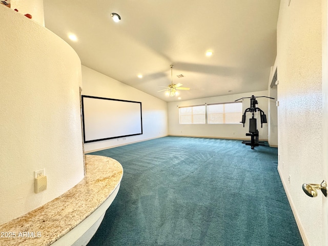 cinema with a ceiling fan, baseboards, vaulted ceiling, carpet flooring, and a textured wall