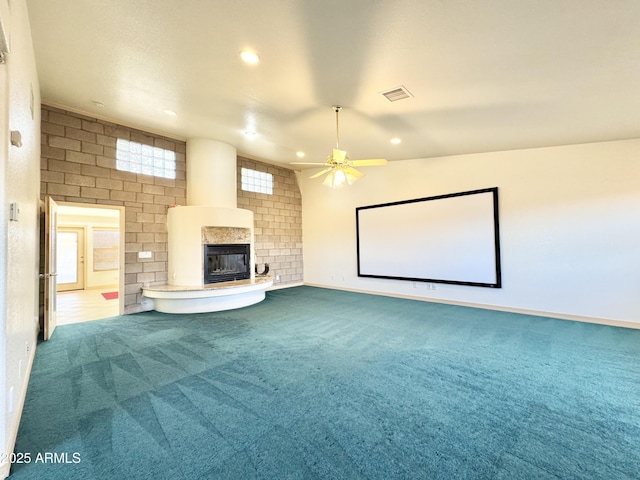 cinema room featuring visible vents, a large fireplace, ceiling fan, carpet flooring, and recessed lighting