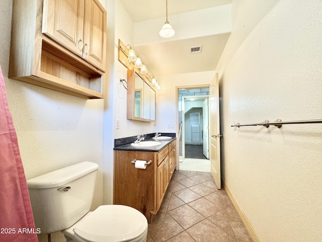 bathroom featuring visible vents, baseboards, toilet, tile patterned floors, and vanity