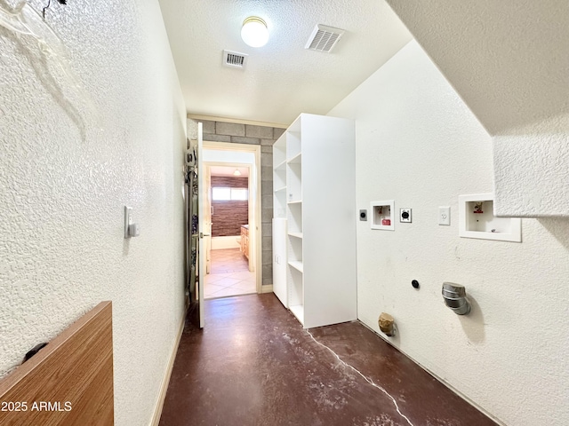 laundry area with hookup for a gas dryer, visible vents, electric dryer hookup, and a textured wall