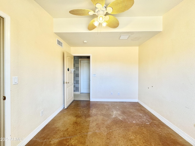 empty room featuring visible vents, a ceiling fan, concrete floors, and baseboards