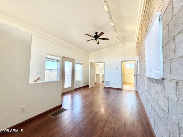 spare room featuring visible vents, ornamental molding, ceiling fan, and dark wood-style flooring