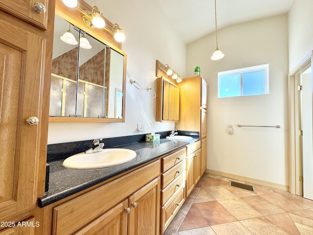 full bath featuring double vanity, visible vents, lofted ceiling, and a sink