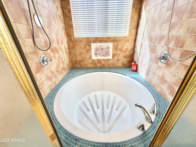 bathroom with a garden tub and a tile shower