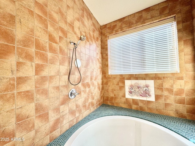 bathroom with a bath and a tile shower