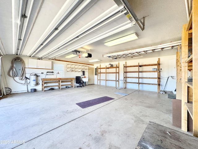 garage featuring water heater and a garage door opener