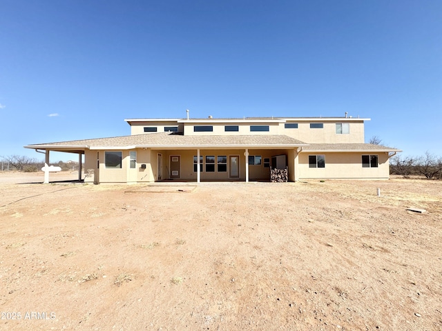 back of house with a patio and stucco siding