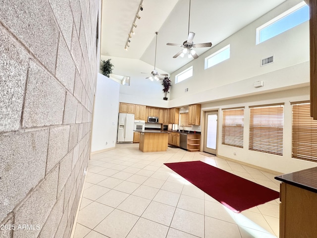 kitchen featuring light tile patterned floors, visible vents, dark countertops, and appliances with stainless steel finishes