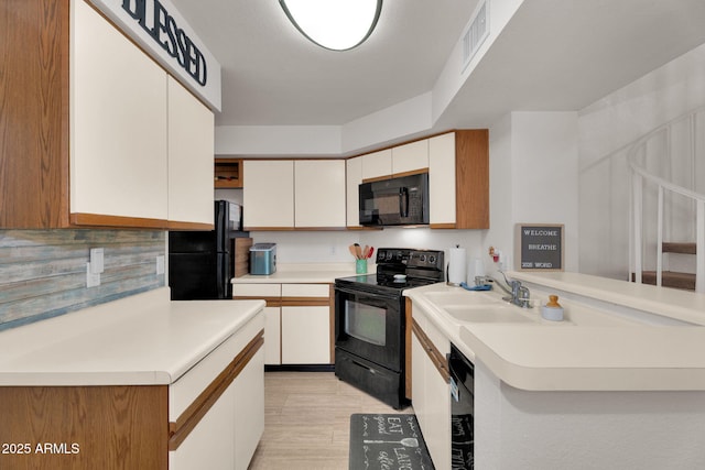 2333 E Southern Ave Unit 2016, Tempe, AZ 85282 - kitchen featuring black appliances, light countertops, white cabinetry, and a peninsula