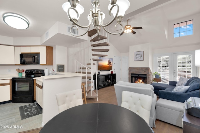 2333 E Southern Ave Unit 2016, Tempe, AZ 85282 - dining space with stairway, a fireplace, high vaulted ceiling, a chandelier, and light wood-style floors
