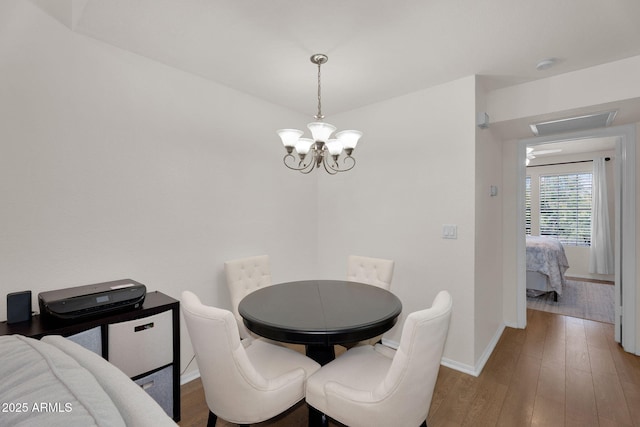 2333 E Southern Ave Unit 2016, Tempe, AZ 85282 - dining room with a chandelier and wood finished floors