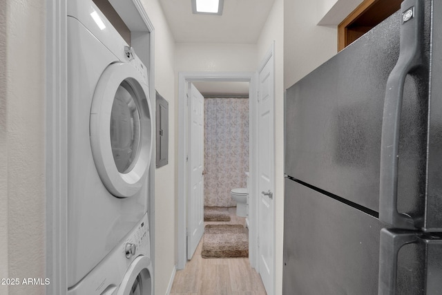 2333 E Southern Ave Unit 2016, Tempe, AZ 85282 - washroom with stacked washer / drying machine and light wood finished floors