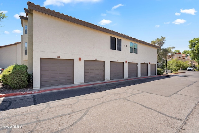 2333 E Southern Ave Unit 2016, Tempe, AZ 85282 - view of home's exterior with community garages, stucco siding, and a tile roof