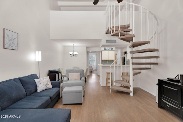 2333 E Southern Ave Unit 2016, Tempe, AZ 85282 - living area with stairs, light wood finished floors, a chandelier, a high ceiling, and ceiling fan