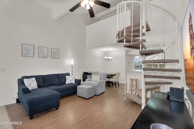 2333 E Southern Ave Unit 2016, Tempe, AZ 85282 - living area featuring stairs, beamed ceiling, a ceiling fan, wood finished floors, and a towering ceiling