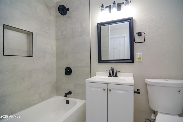 full bath with toilet, a textured wall, shower / washtub combination, and vanity