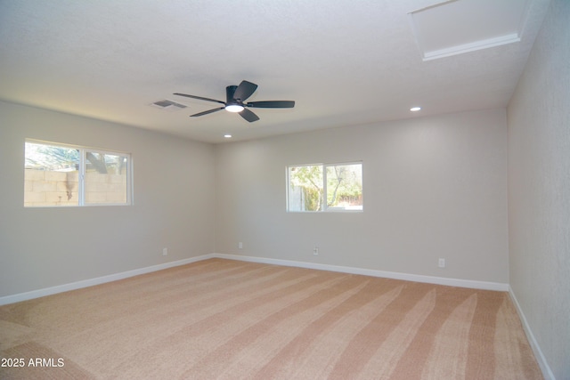 empty room featuring recessed lighting, light colored carpet, visible vents, attic access, and baseboards