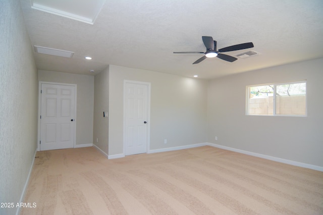 spare room with recessed lighting, visible vents, attic access, light carpet, and baseboards