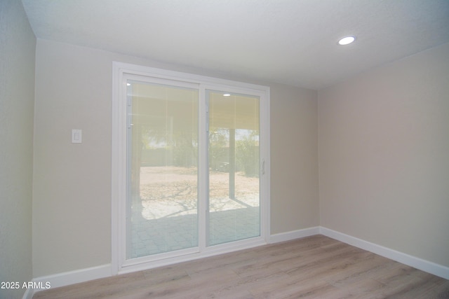 doorway to outside featuring recessed lighting, light wood-style flooring, and baseboards