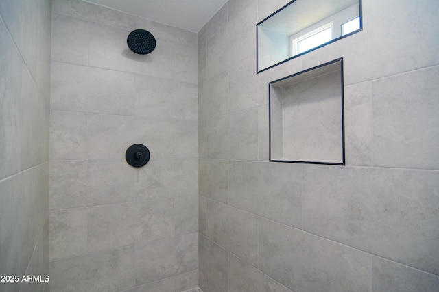 bathroom with a tile shower